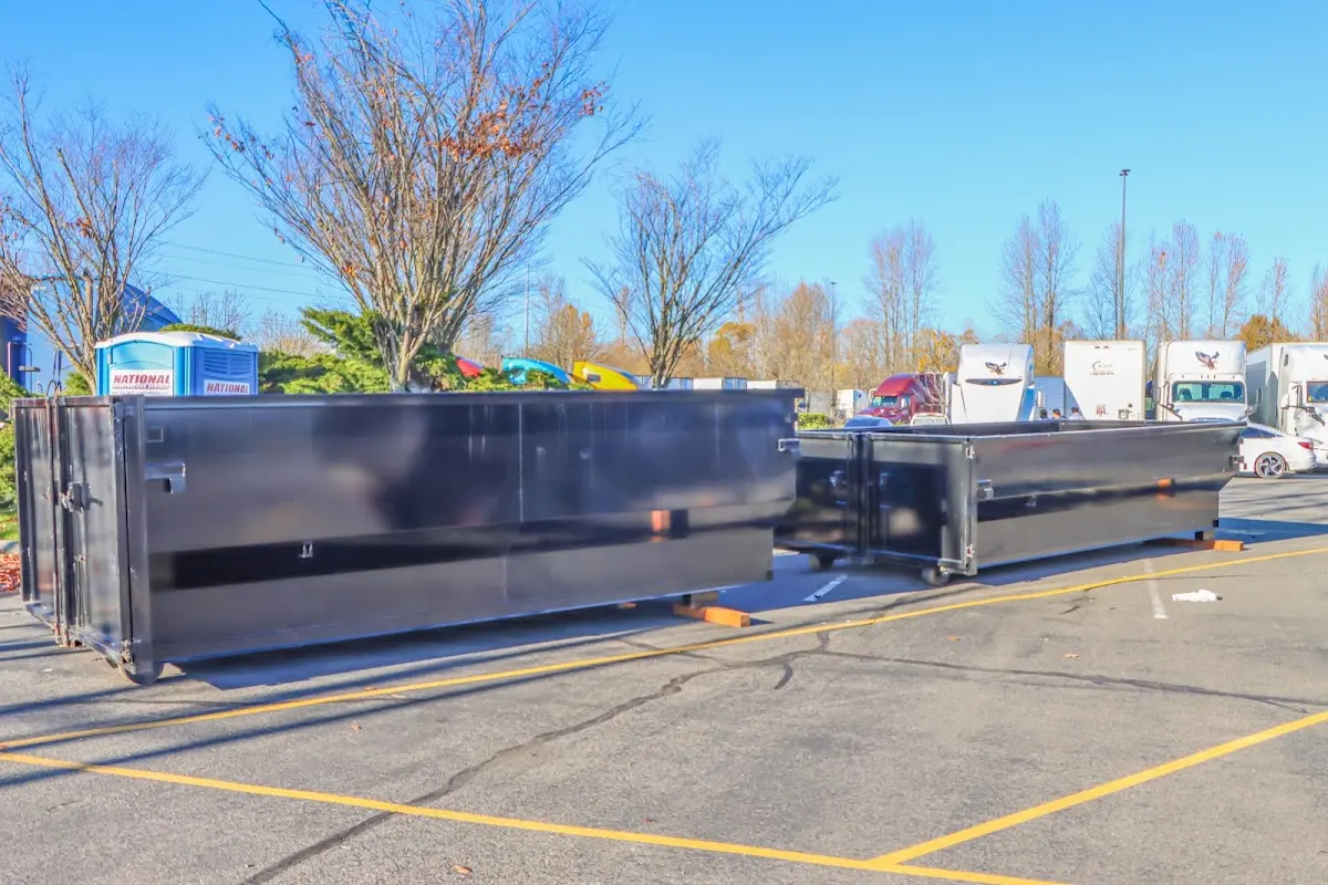 Professional dumpster rental service with roll-off container on residential driveway in New Square
